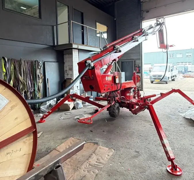 REGBES crane arm CMS — front view, outriggers deployed, workshop assembly